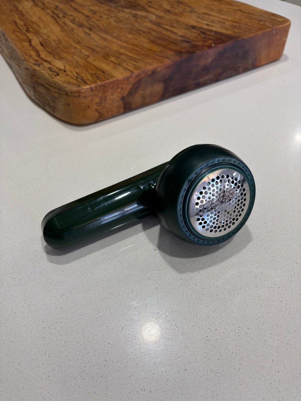 Electric clothing lint remover removing fuzz from fabric