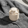 Beige electric fabric lint remover shaving pills off sweater